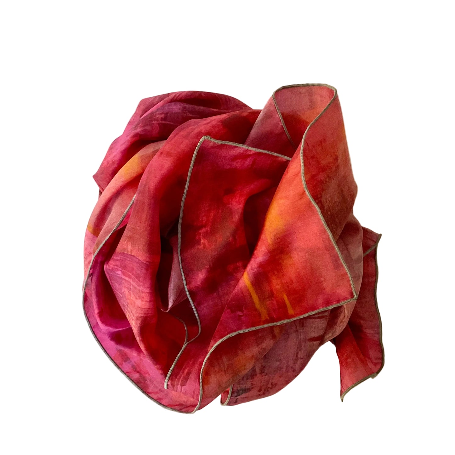 Red and orange fabric draped over a white surface